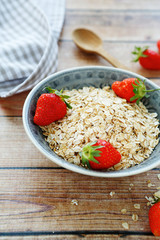 raw flakes with strawberries in a bowl