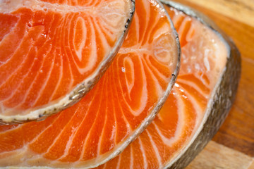 Delicious  portion of fresh salmon fillet on a wooden table