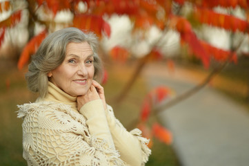 Senior woman in park autumn park