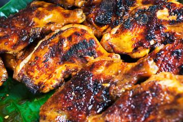 Chicken grilled on white dish .