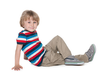 Blond boy sits on the floor
