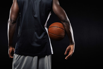 African basketball player with a ball in his arm - Powered by Adobe
