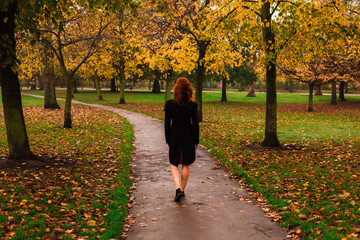 Fototapeta premium Young woman walking in park