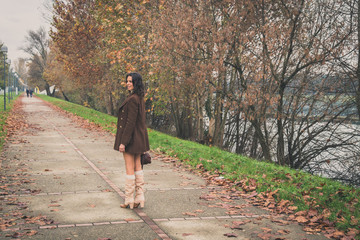Fototapeta premium Beautiful young woman posing in a city park