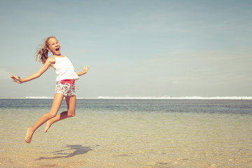 teen girl  jumping on the beach