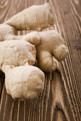 Fototapeta premium Ginger root sliced on wooden table