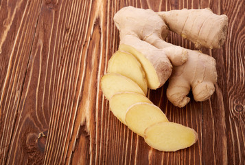 Ginger root sliced on wooden table