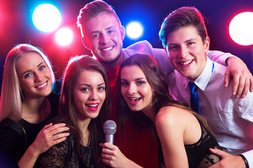 Young people singing at party