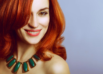 Fototapeta premium Emotive portrait of a fashionable model with red (ginger) curly