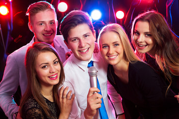 Young people singing at party