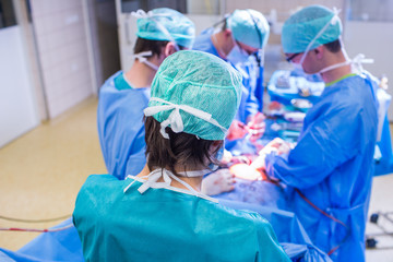 Team of surgeons performing an operation on a patient