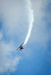 Fototapeta na wymiar Acrobatic plane in smoke action during airshow