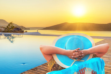 Woman in hat enjoying sun holidays in Greece