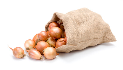 Yellow onions in burlap bag