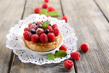 Sweet cakes with berries on table close-up