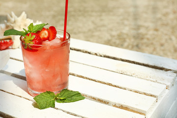 Refreshing cocktail on table, outdoors