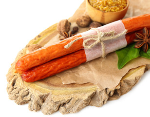 Smoked thin sausages, mustard in bowl and spices