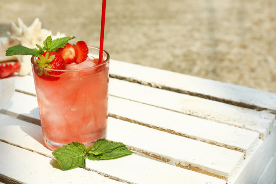 Refreshing cocktail on table, outdoors