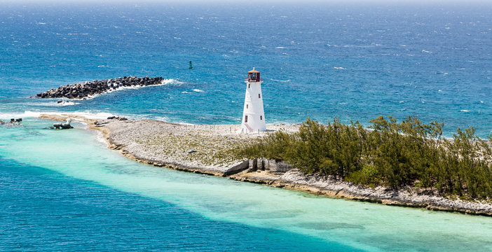 Small White Lighthouse on Strip of Land in Caribbean