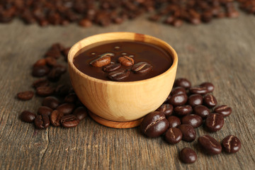 Coffee beans with chocolate glaze on wooden background