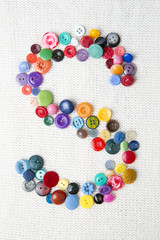 Letter S of the alphabet of buttons of various shapes and colors