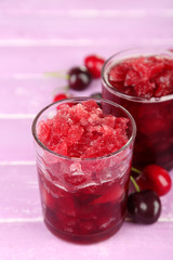 Closeup of cherry granita in glasses, on color wooden