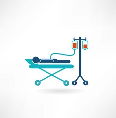 donor lies on a gurney and blood transfusions icon