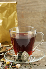 Beautiful vintage composition with herbal tea, on wooden table