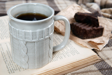 Cup of tea with book on table close-up