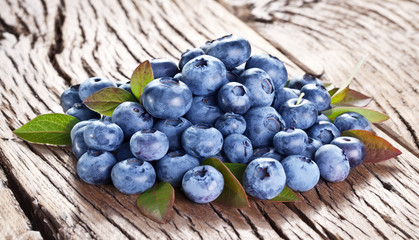 Blueberries over old wooden table.
