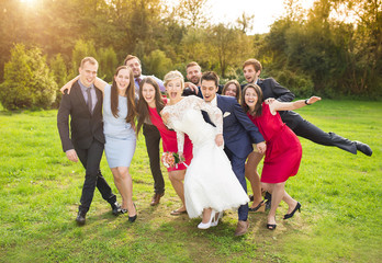 Newlyweds with guest posing in park