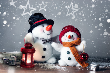 Two smiling snowmen  in the snow, no name toy