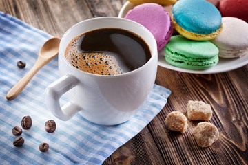 Cup of coffee and french macaron.