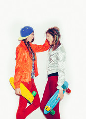 Two young girl friends standing having fun together