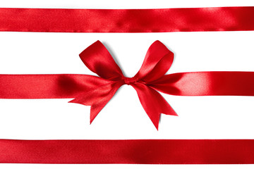 Shiny red satin ribbon on white background