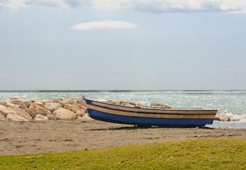 Naklejka na ściany i meble Small fishing boat on Spanish Beach