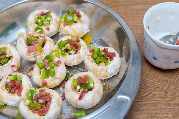 Preparing mushrooms stuffed with ham and pepper