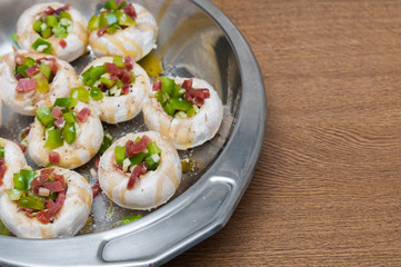 Preparing mushrooms stuffed with ham and pepper