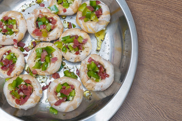 Preparing mushrooms stuffed with ham and pepper