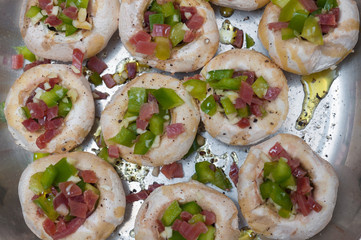 Preparing mushrooms stuffed with ham and pepper