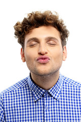 Fototapeta premium Portrait of a handsome young man kissing camera