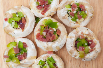 Preparing mushrooms stuffed with ham and pepper
