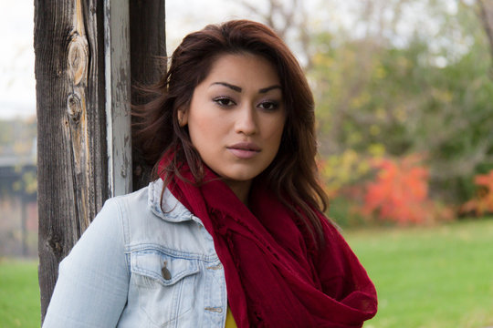 Hispanic woman outdoors with red scarf
