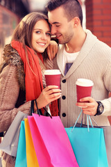 Happy couple with coffee shopping in the mall