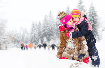 Fototapeta na wymiar Children having fun in the snow