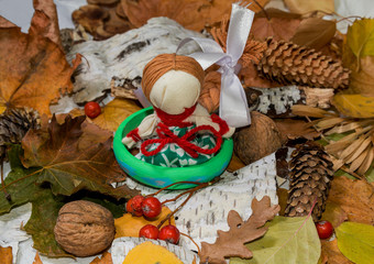 Autumn background. Traditional Ukrainian "motanka" doll-guarded