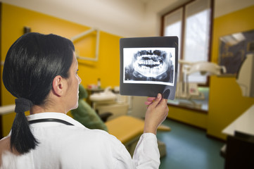 Dentist checking x-ray at dental clinic