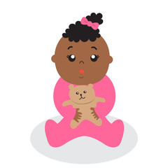 A baby girl holding a teddy bear