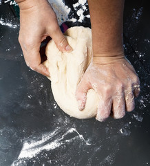 Hands kneading a dough
