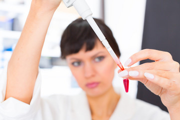 woman in a laboratory with microtube test tube  in hand and PCR